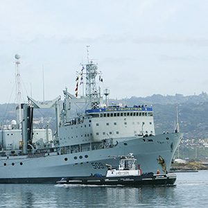 The Royal Canadian Navy ship HMCS Protecteur arrives at Joint Base Pearl Harbor Hickam after it was towed by the U.S. Navy ship USS Sioux after a fire disabled it while at sea in Honolulu, Hawaii, March 6,2014. (Hugh Gentry/Reuters)