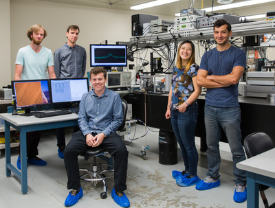 From left: David Lake, Paul Barclay, Matthew Mitchell, Tamiko Masuda, and Behzad Khanaliloo. Barclay, associate professor of physics and astronomy and Alberta Innovates Scholar in Quantum Nanotechnology in the Faculty of Science, and his students fabricated a quantum microdisk from commercially available synthetic, single-crystal diamond chips. Photo by Riley Brandt, University of Calgary.