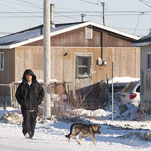 A man walks down the street in Attawapiskat, Ont., Tuesday November 29, 2011. (Adrian Wyld/CP)
