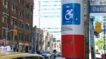 An proposed design to update the International Symbol of Access is shown on a sticker in downtown Toronto.